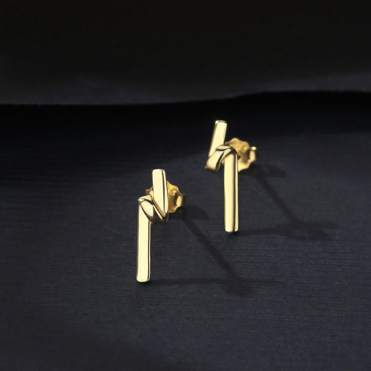 Minimal gold-tone stud earring shaped like a slim bar folded over at the top