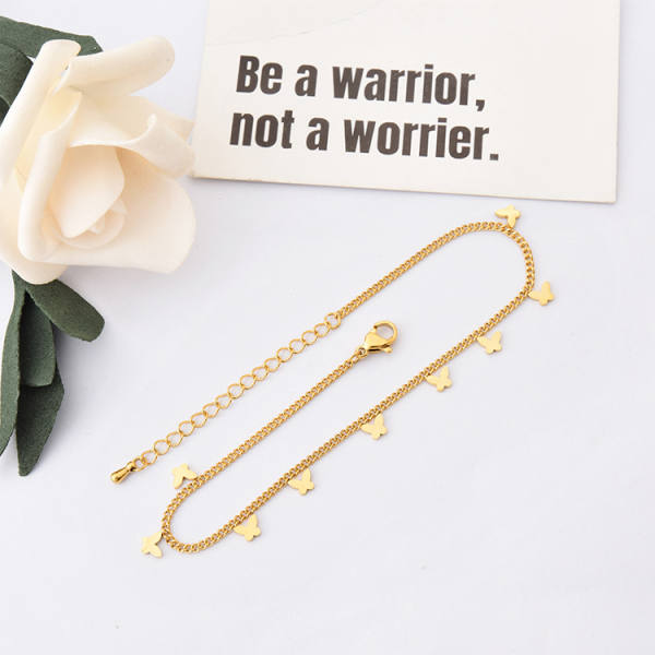 Gold-tone curb chain anklet with small flat butterfly charms spaced along its length