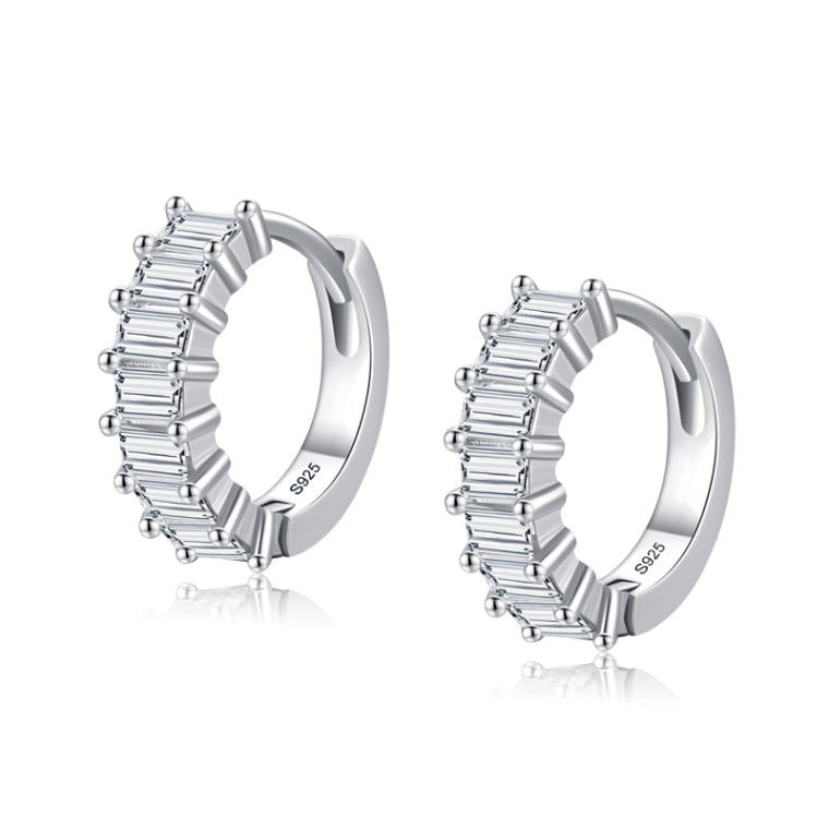 Small silver-tone huggie hoops lined across the front with rectangular baguette-cut clear stones