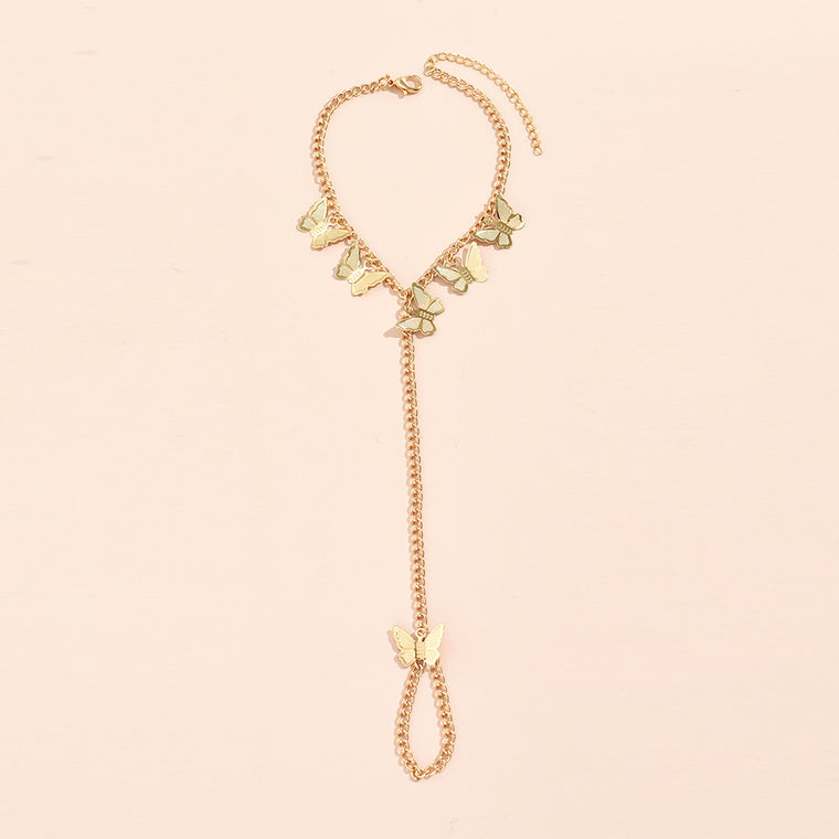 Gold curb chain bracelet hung with five flat butterfly charms, a chain running to a butterfly-topped chain finger loop