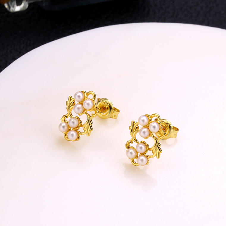 Gold-tone stud earrings with two small clusters of tiny pearls and leaf detail