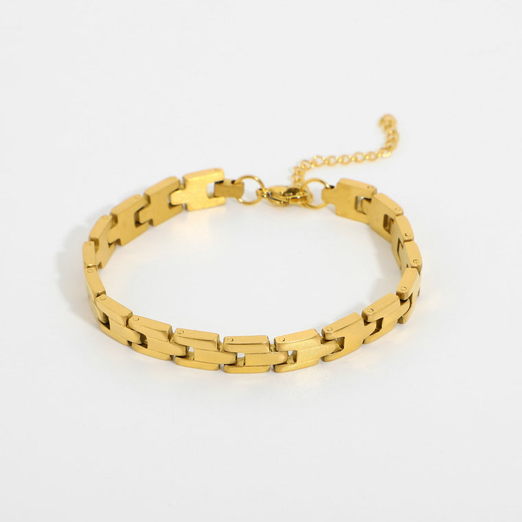 Slim gold flat-link band bracelet with a lobster clasp and a fine extender chain