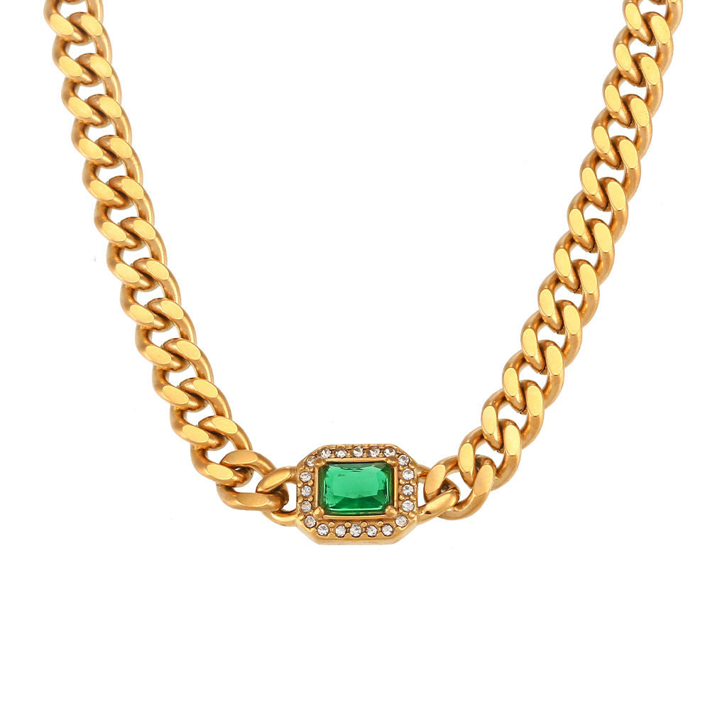 Gold-tone curb chain necklace and bracelet, each with one emerald-cut colored stone in a pavé halo at the center