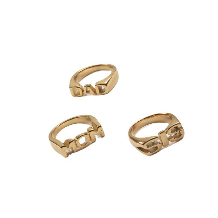 Gold rings with the block capital words DAD, SIS, FAM, BRO and MOM standing proud of the band
