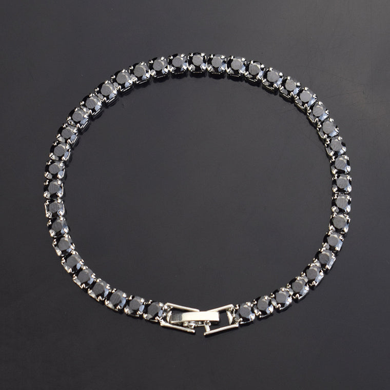 Tennis bracelets with round colored stones — white, pink, blue, green, black and aqua — with fold-over clasps, shown in silver and in gold