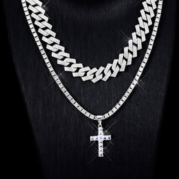 Pavé cubic zirconia cross worn on a tennis chain with an iced cuban chain layered above, in gold-tone and silver-tone