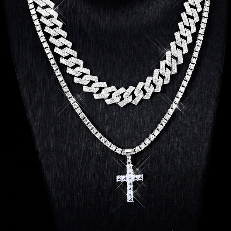 Pavé cubic zirconia cross shown on a tennis chain with an iced cuban chain layered above; the chains come only with the chain options