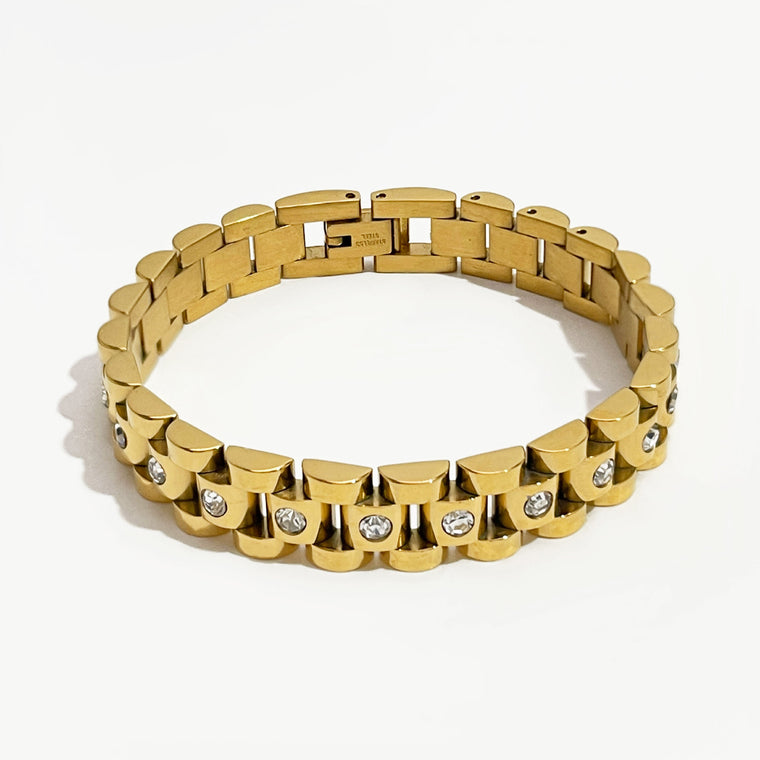 Five-row link band bracelet with a round clear stone set into every center link, shown in gold and in steel