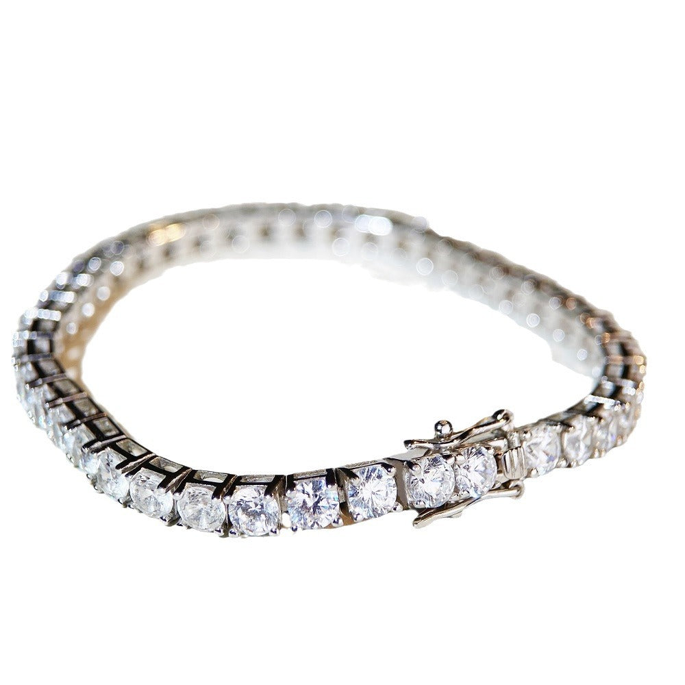 Single-row tennis bracelet of round prong-set stones, shown on a neutral ground and worn on the wrist