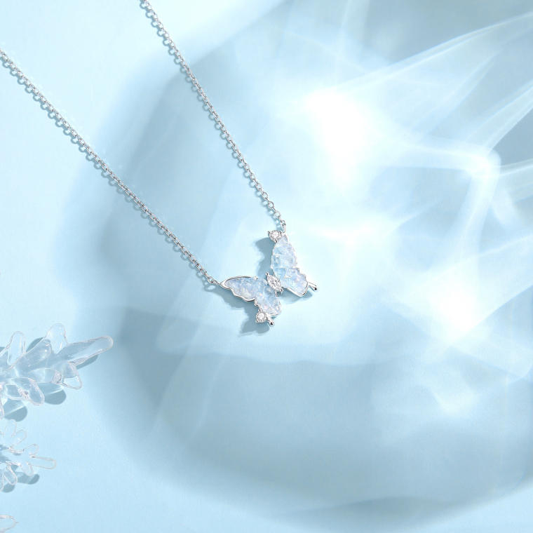 Silver-tone chain with a pale-blue crushed-ice butterfly pendant and small clear stones